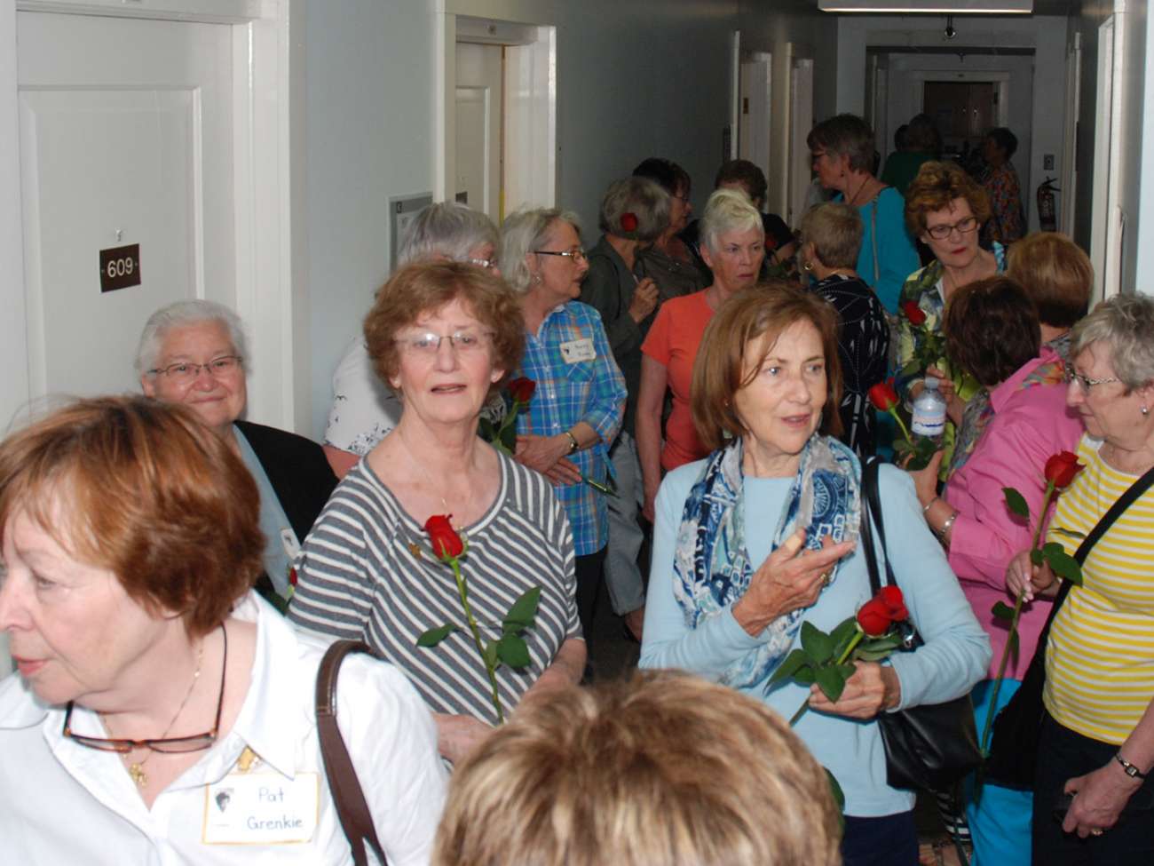 Tour participants in the Kaufman building, their former residence as nursing students