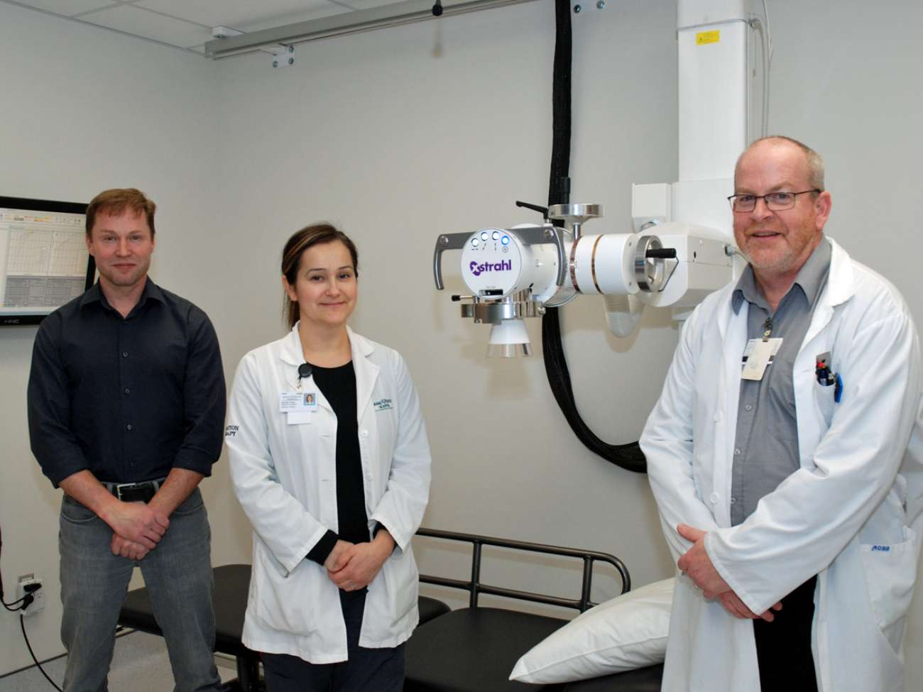 Medical physicist Andre Fleck as well as radiation therapists Andrea Tonin and Bruce Fleming pause inside of the new orthovoltage suite at GRH's regional cancer centre.