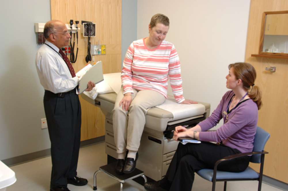 A photo of a patient and two care providers during an appointment