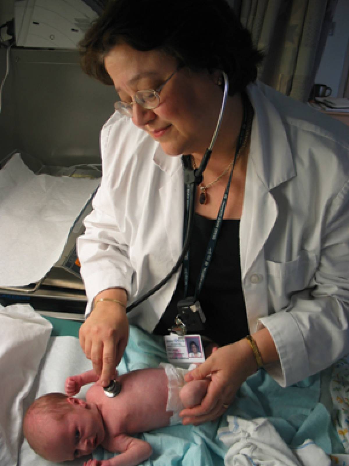 A photo of a nurse with a newborn baby