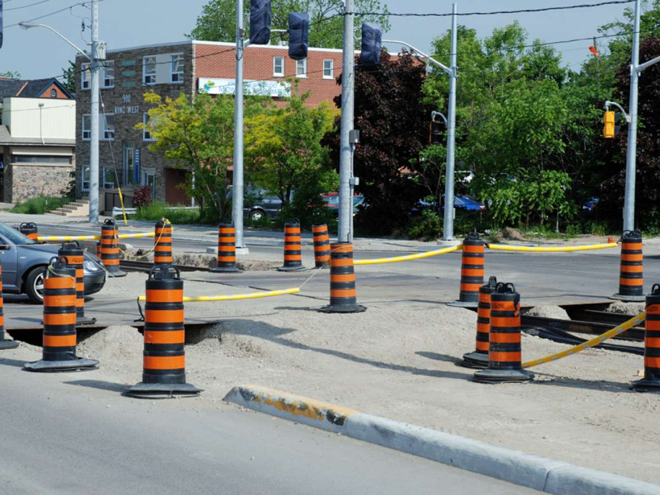 Trenches at the King and Pine intersection, with steel plates allowing traffic and pedestrians to cross normally.