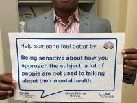Dr Okonkwo's sign reads: help someone feel better by being sensitive about how you approach the subject; a lot of people are not used to talking about their mental health.thumbnail image.