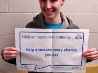 Megan's sign reads: Help someone every chance you get.thumbnail image.