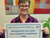 Jaylene's sign reads: help someone feel better by being kind to each other. Give someone a compliment today.thumbnail image.