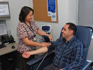 A photo of a patient getting their blood pressure taken