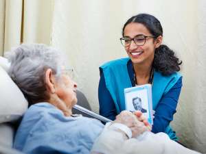 Shwetha Suresh volunteers with a patient at GRH's KW Campus