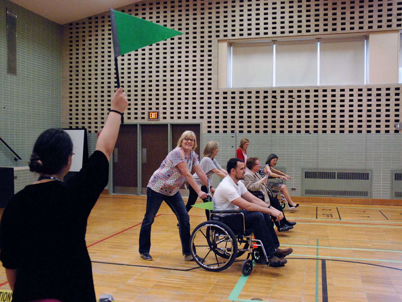 Enjoying a celebratory wheelchair race to honour the association's contribution.