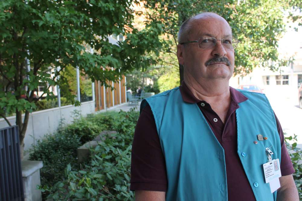 Guy Wellhauser stands in front of GRH's regional cancer centre