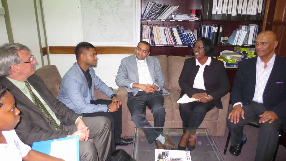 Dr. Peter Kuhnert (second from left) and Dr. Shrenik Parekh (third from right) meet with mental health leaders in Guyana.