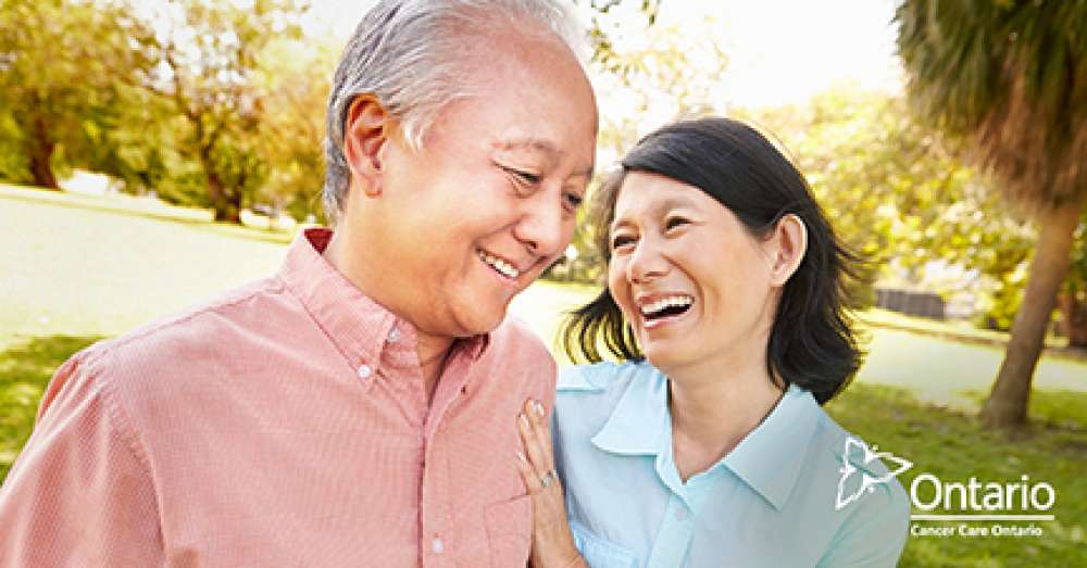 A photo of a man and a women interacting with one another