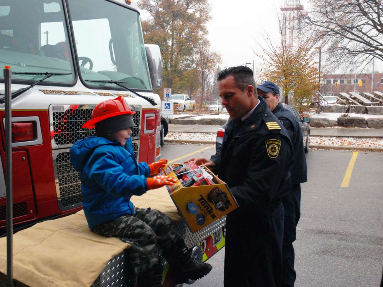 Kitchener's Deputy Fire Chief Bob Gilmore gives Evan his very own fire truck