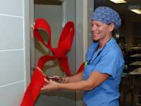 MDR tech Marilyn Shand cuts the ribbon for the renovated room housing the trophon (R) units.thumbnail image.