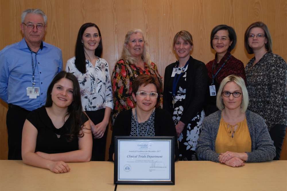 Members of the clinical trials receive their award of excellence from hospital leaders