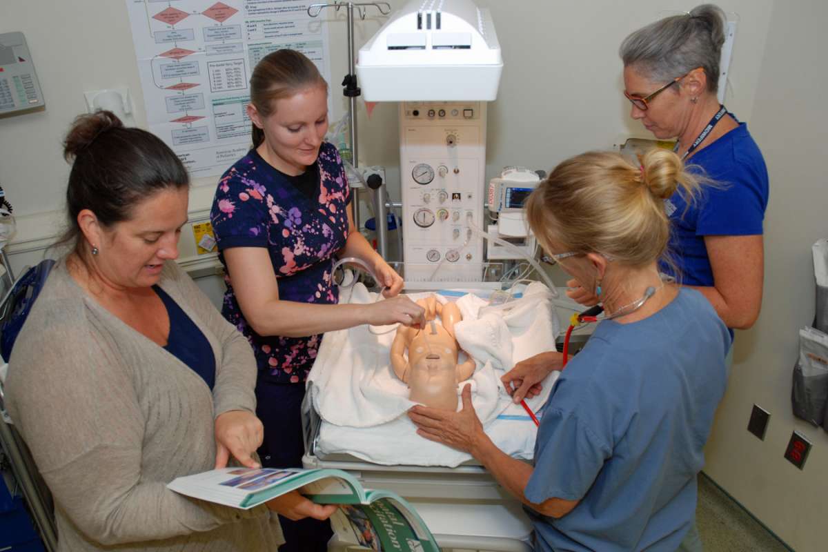 Sheri Douglas coaches a team as they practice their neonatal resuscitation skills