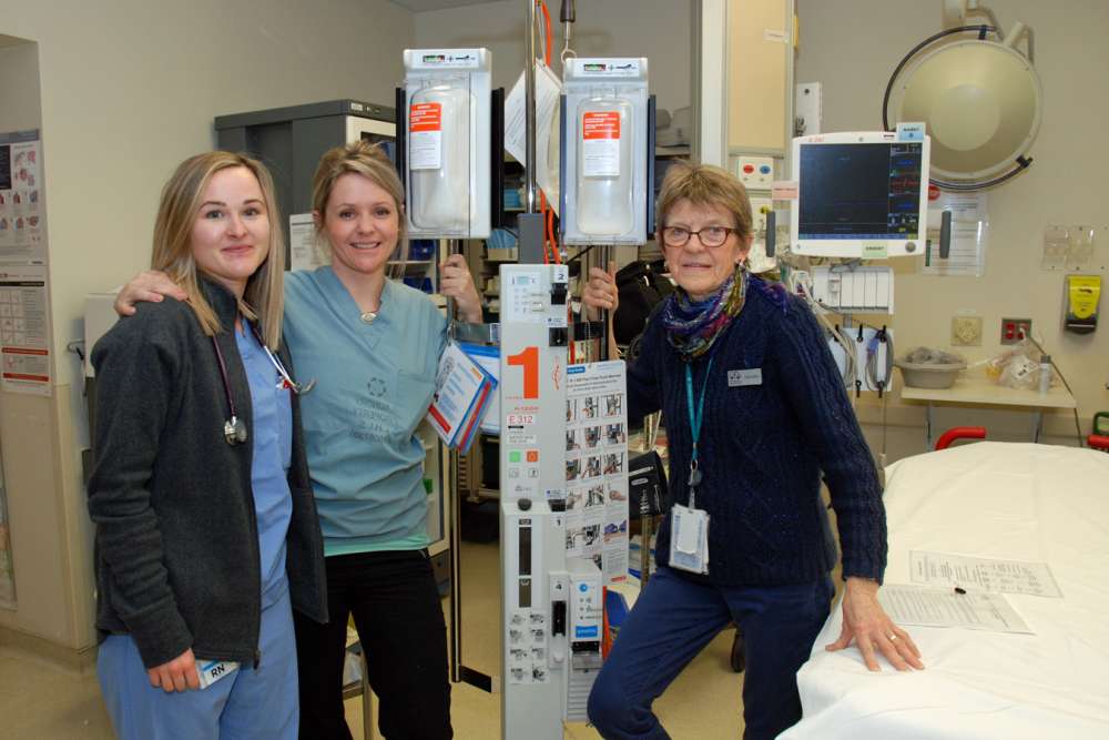 Left to right- registered nurses Josslyn and Stephanie review a rapid infuser in GRH's trauma room with the help of Jane Foster