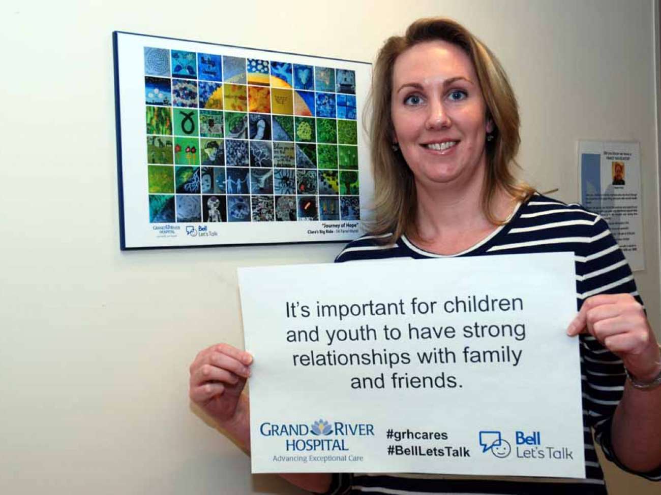 A care provider with a poster reading: It’s important for children and youth to have strong relationships with family and friends.