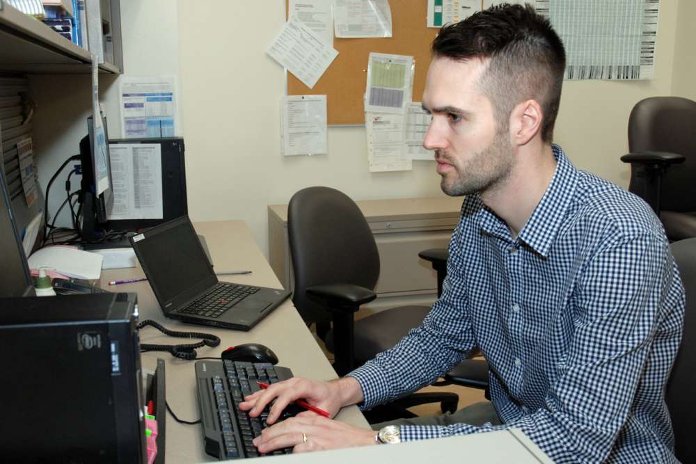 Jack Bodkin reviews orders in GRH's inpatient pharmacy