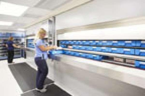 A photo of a pharmacy technician preparing patient medication