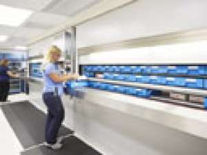 A photo of a pharmacy technician preparing patient medication