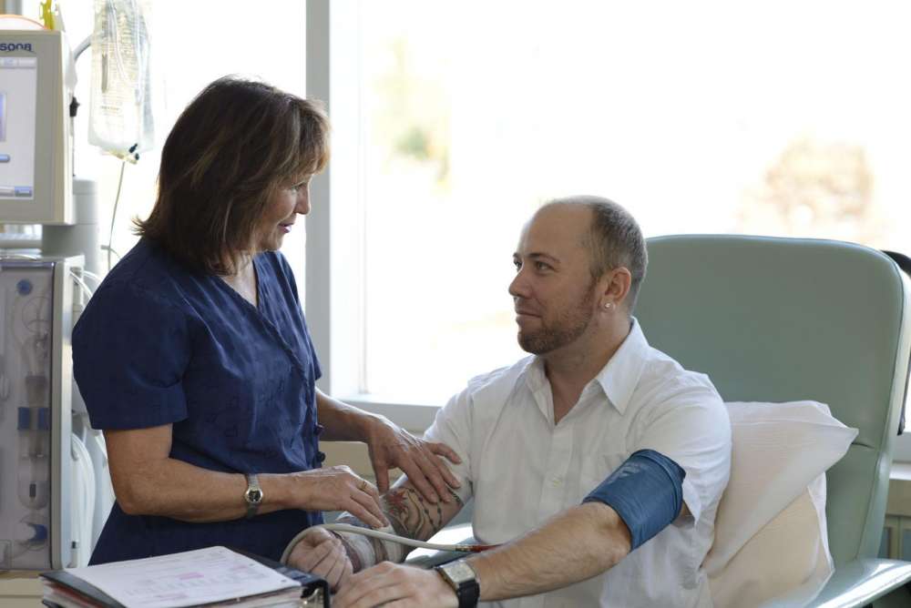 A photo of a care provider and a kidney patient