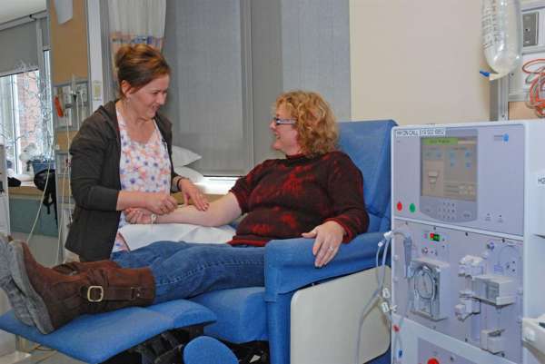 A photo of a renal nurse and patient