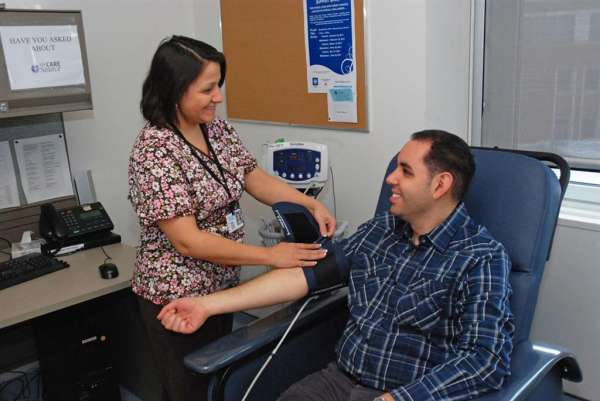 A photo of a patient getting their blood pressure taken