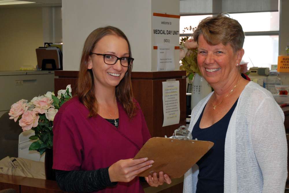 Clinical assistant Christie and clinical manager Jane Huiskamp discuss upcoming cases in GRH's medical day unit.