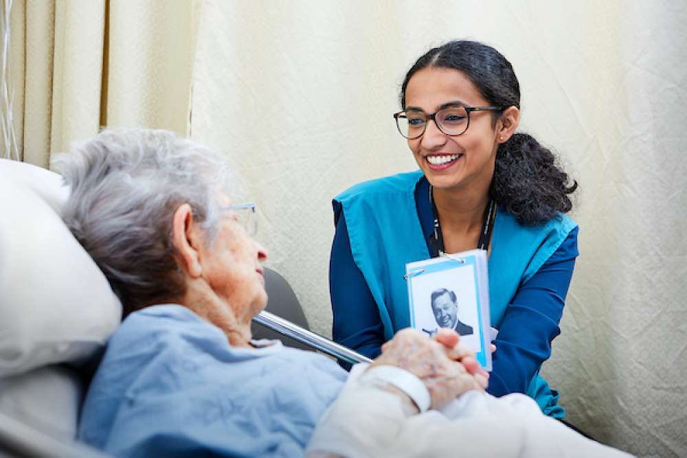 Shwetha Suresh volunteers with a patient at GRH's KW Campus