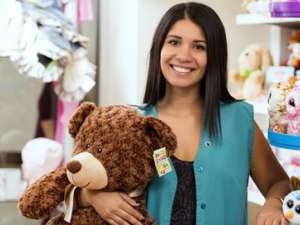 A photo of a volunteer holding a teddy bear