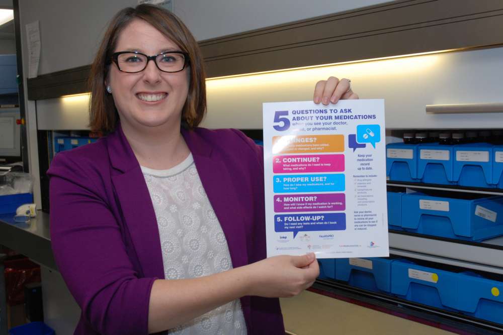 Kari Soontiens holding a poster