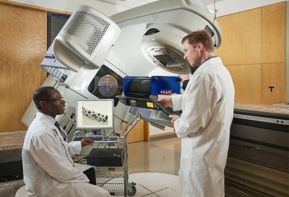Dr. Ernest Osei works with Dr. Andre Fleck on a research initiative in the Grand River Regional Cancer Centre