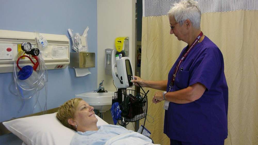 A nurse providing care for a patient