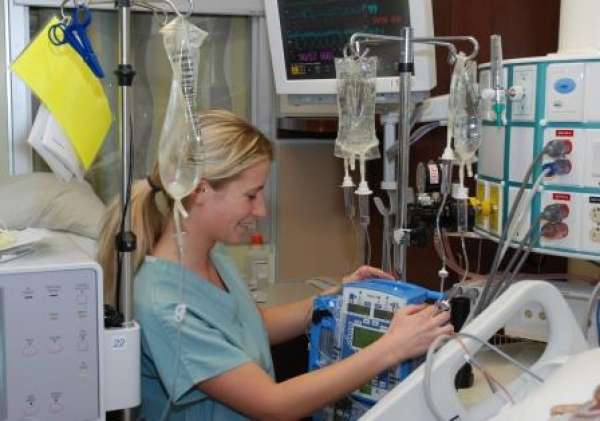 A photo of an ICU nurse surrounded by critical care equipment