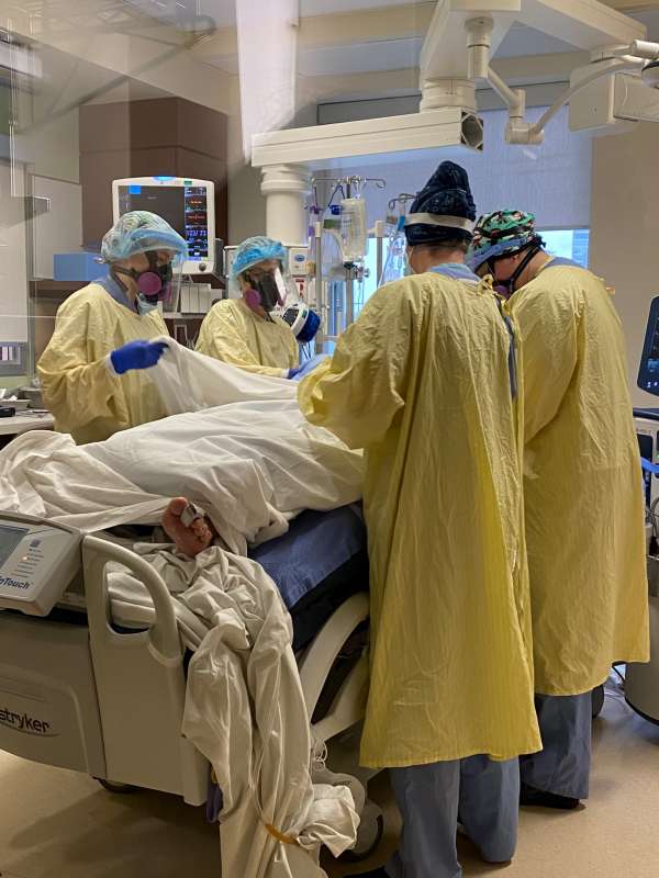 Prone team prepping to move patient
