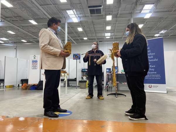 Brian Dokis, Myeengun Henry, and Rachel Radyk participate in opening ceremony for Indigenous immunizers at the vaccine clinic