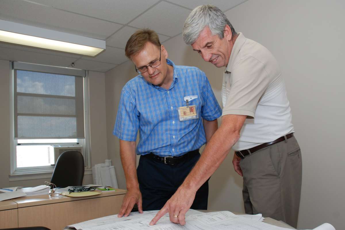 Angelo Ceccato and facilities director Kevin Wilson discuss an upcoming renovation project