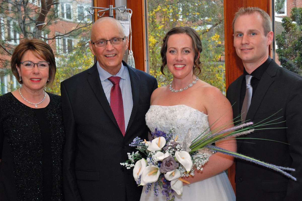 Mother and father of the bride Carolyn and David Gardy stand with the happy couple: Tricia and Doug