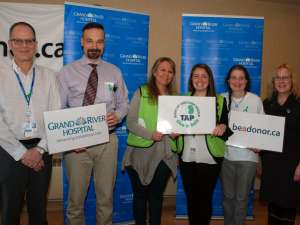 A group of people standing together at an organ donation event