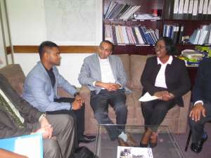 Dr. Peter Kuhnert (second from left) and Dr. Shrenik Parekh (third from right) meet with mental health leaders in Guyana.