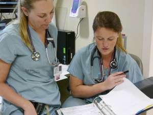 A photo of two resident physicians in the ICU