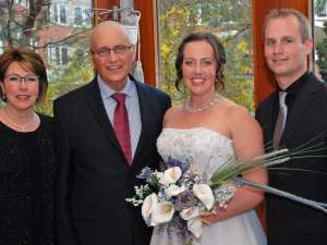 Mother and father of the bride Carolyn and David Gardy stand with the happy couple: Tricia and Doug