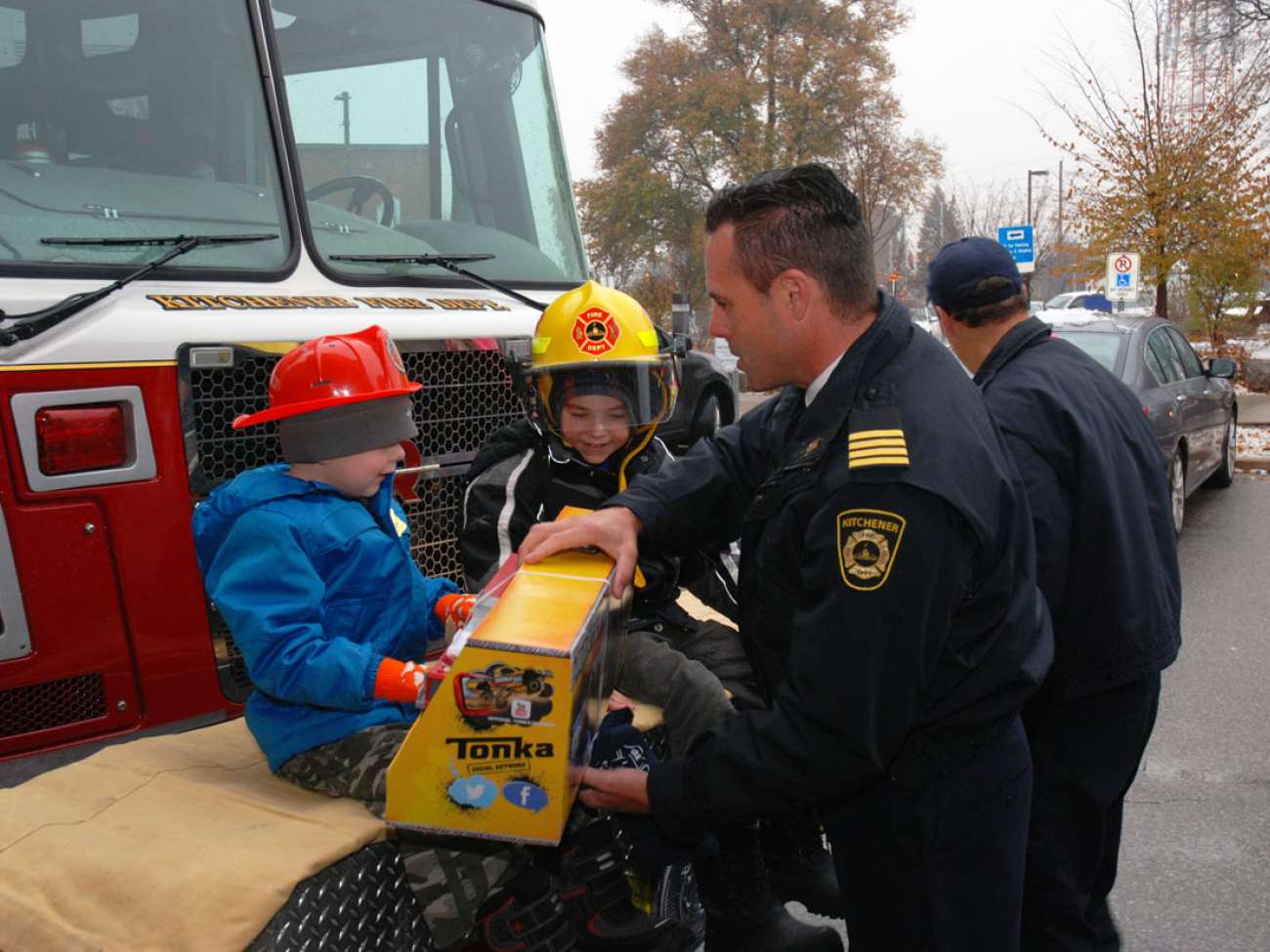 Kitchener's Deputy Fire Chief Bob Gilmore gives Evan his very own fire truck