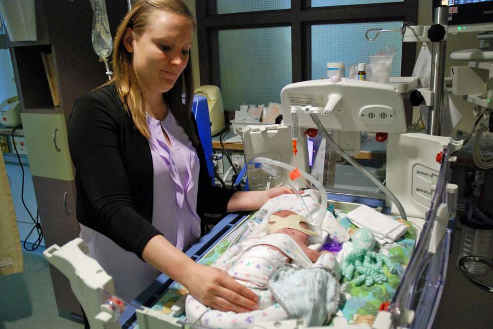 Jessica shows some of the positioning aides in place to support baby Arthur as he sleeps in GRH's NICU